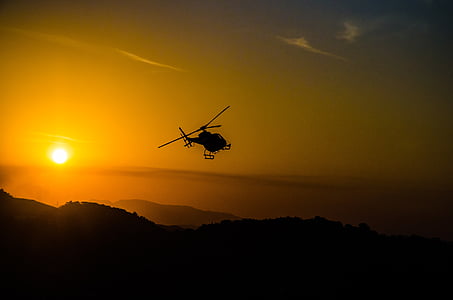 silhouette of helicopter with sunlight