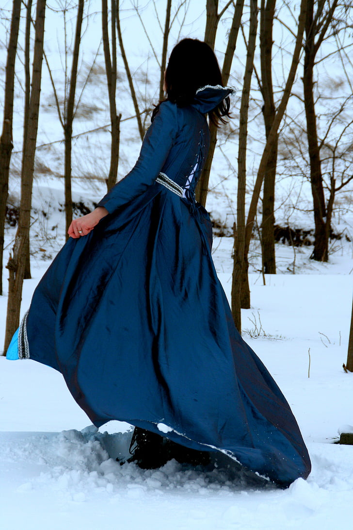 woman in blue dress walking on snow