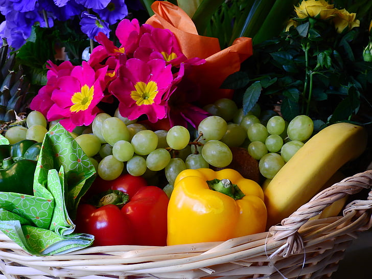 basket of fruits, vegetables and petaled flowers