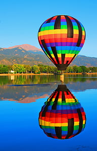 hot air balloon over body of water