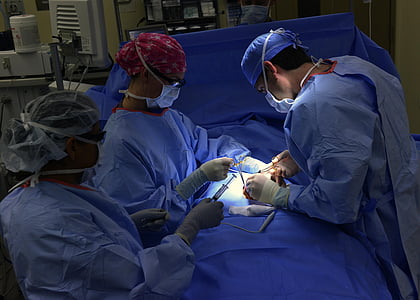 three person wearing blue hospital gowns
