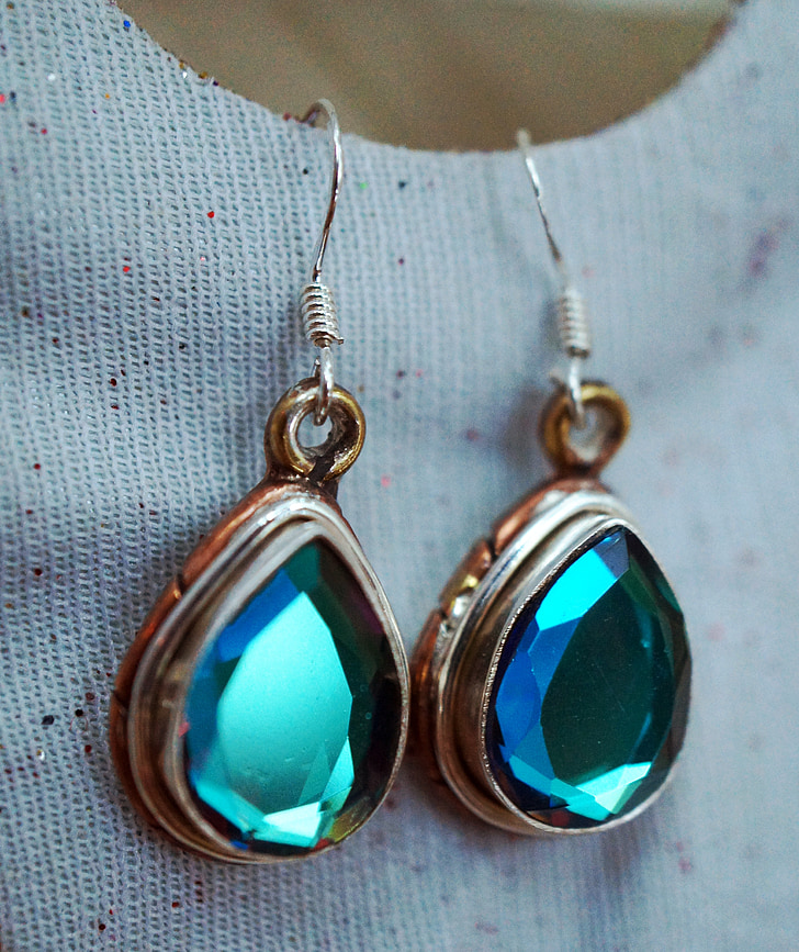 pair of gold-and-silver-colored pendant hook earrings with green gemstones