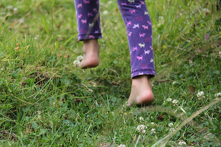 person in purple animal print pajama pants on grass field