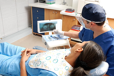 dentist checking woman teeth