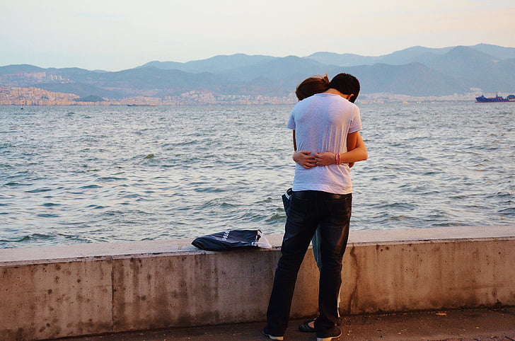 couple embracing near ocean