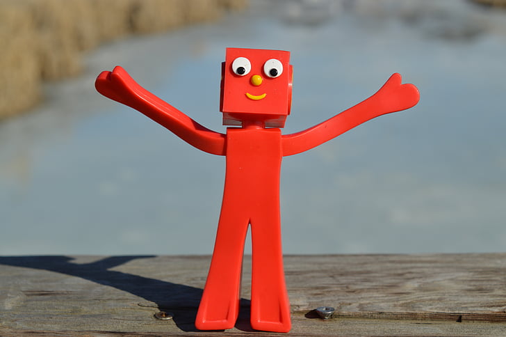 red character figurine on wooden surface