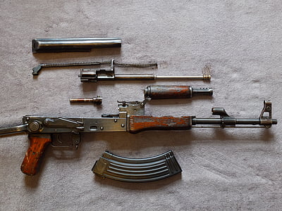 disassembled gray and brown rifle