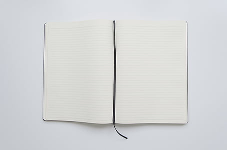 opened white book on white surface