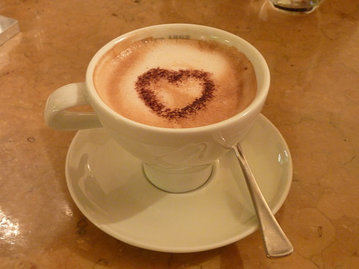 white ceramic coffee with heart decor
