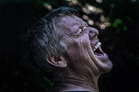 closeup photography of man sticking his mouth open