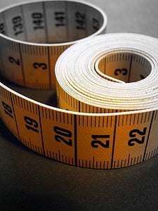 yellow and black tape measure on gray surface
