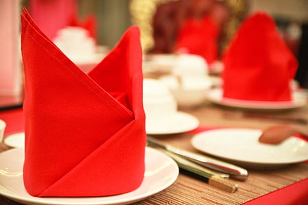 selective focus photography of red table cloth on white ceramic plate