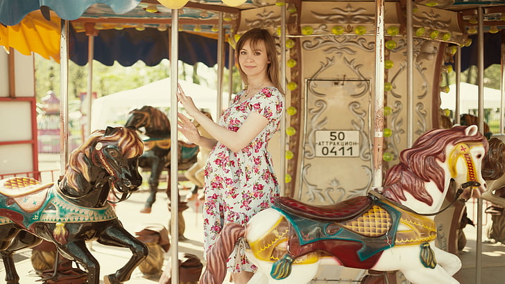 woman standing on carousel