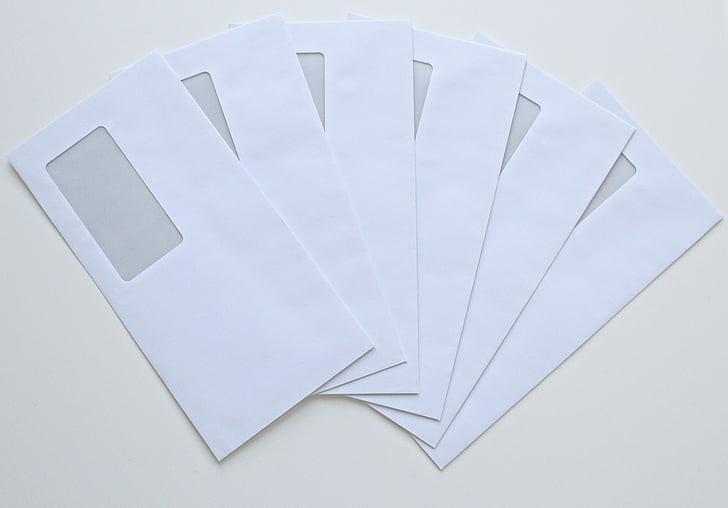 six white windowed envelopes