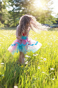 shallow focus photography of girl on green grass