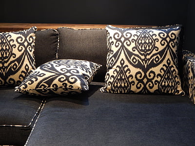 three throw pillows on black couch