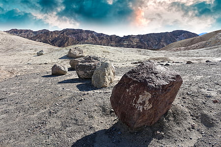 gray stones near mountain at daytime