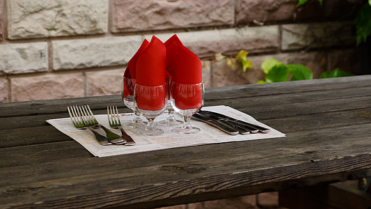 four stainless steel forks and clear footed drinking glasses