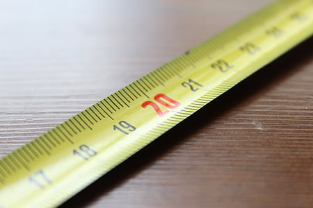 20 inches steel tape measure on brown wooden surface