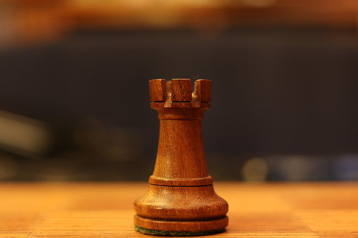 brown chess piece on brown wood