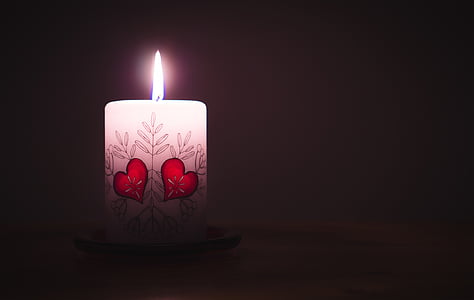 close-up photo of white lighted candle