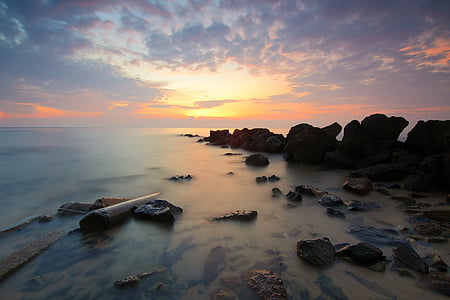 photo of sea boulders during golden hour