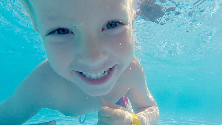 boy posing smile underwater