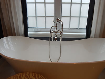 drop-in bathtub beside window