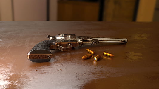 silver revolver on wooden table