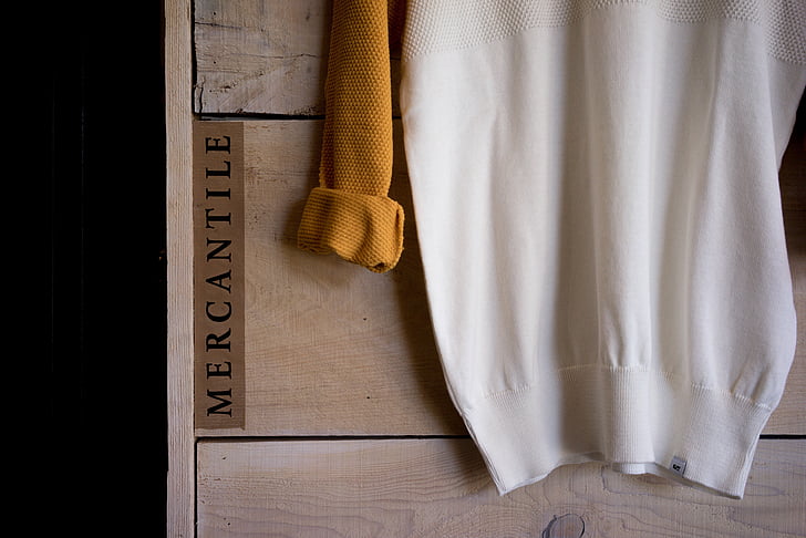 white and brown Mercantile sweatshirt on brown board