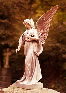 angel figurine in selective focus photography