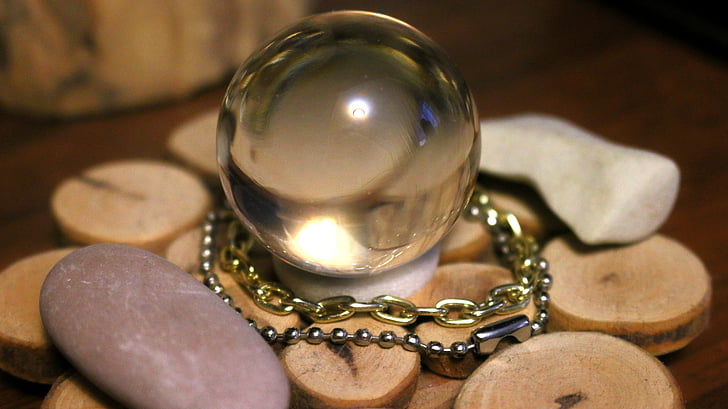 selective focus photography of crystal ball on round brown surface