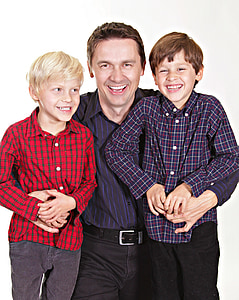 man wearing black and purple dress shirt in between of two childs