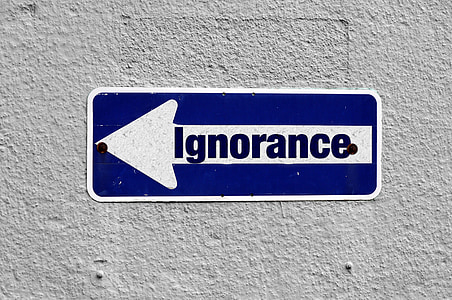 blue and white Ignorance metal signage
