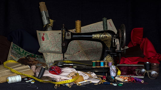 black treadle sewing machine surrounded by assorted items