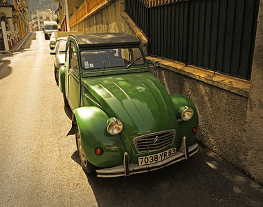 classic green Citroen car parks near concrete wall