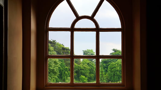 brown wooden arc framed glass window