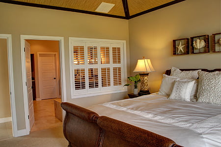 closeup photo of brown wooden bed frame and white wooden door open