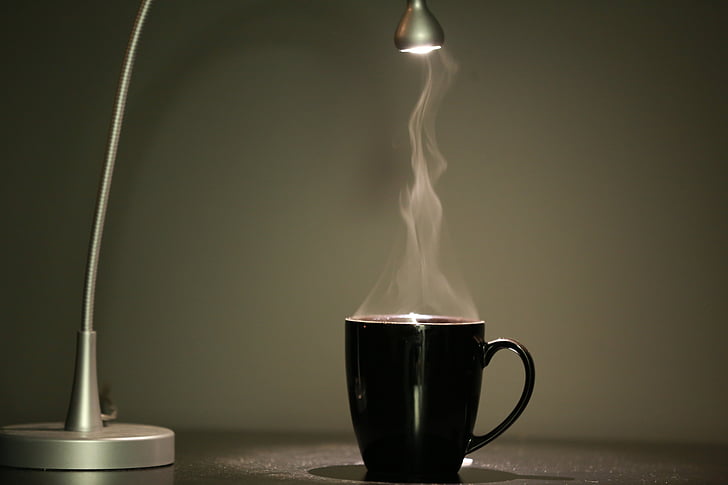black mug near grey table lamp