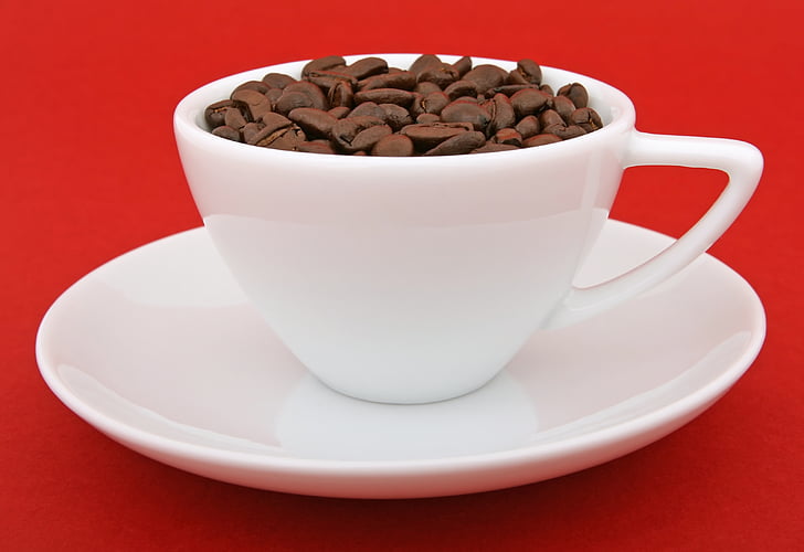 teacup filled with coffee beans