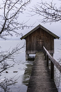 brown wooden shelter on body of water