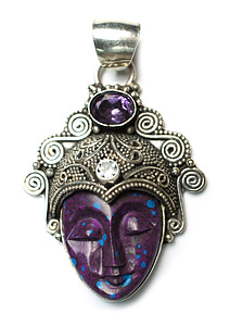 silver-colored pendant with purple gemstone