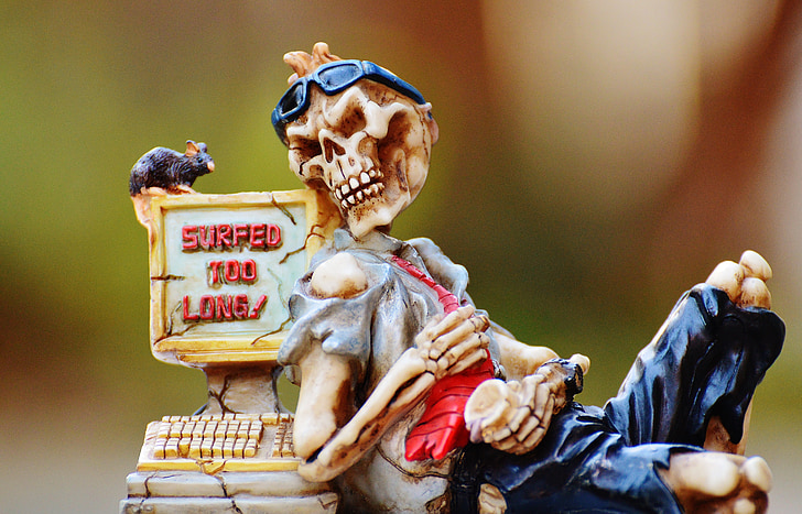 skeleton and cash register figurine