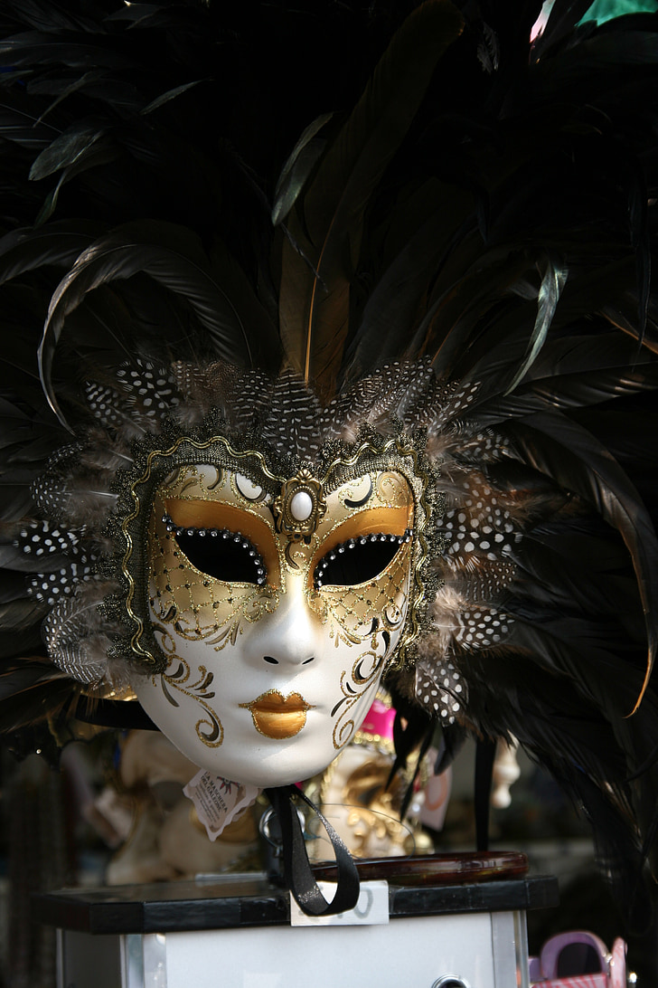 selective focus of white and gold masquerade