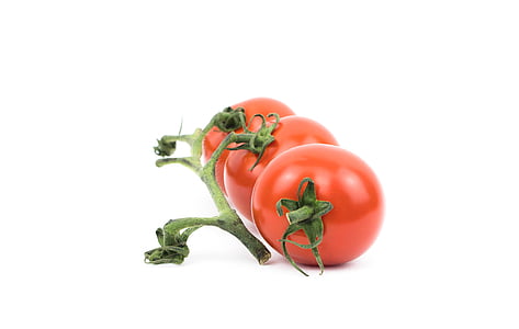 closeup photo of three orange tomatoes