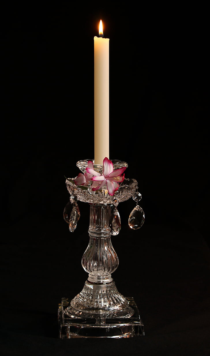 white pillar candle on clear glass candle holder