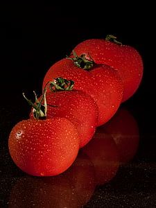 closeup photo of four red tomatoes