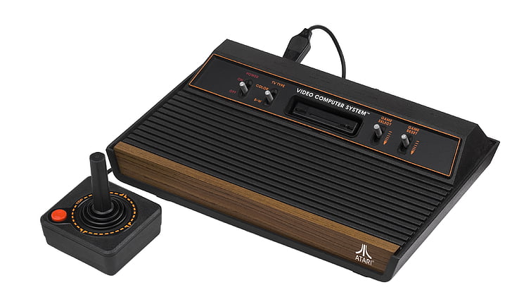 brown and black Atari with joystick