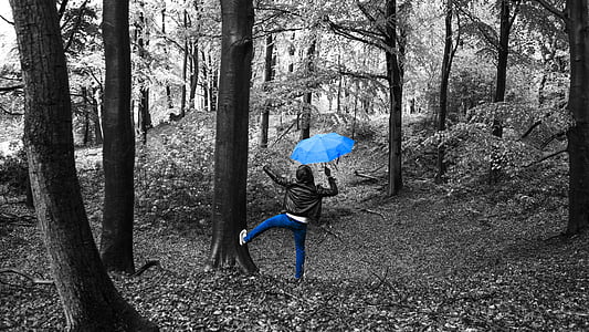selective color photography of person holding umbrella