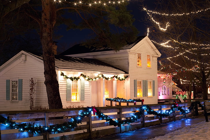 white painted house surrounded by turned on string lights